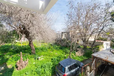 a car parked in the yard of a house at Eln's Sunlit Apartment in Rhodes Town