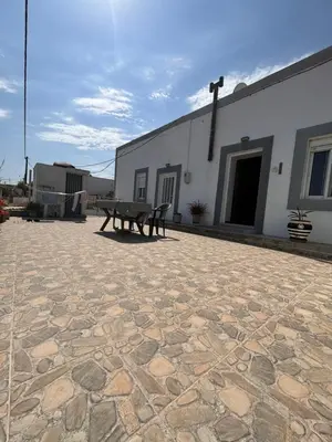 a stone patio with a bench in front of a building at House of Happiness Rhodos in Kritinía