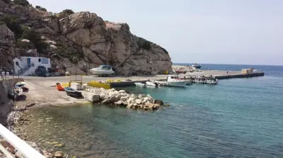 a group of boats in the water near a beach at House of Happiness Rhodos in Kritinía