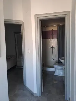 a bathroom with a toilet and a sink in a room at House of Happiness Rhodos in Kritinía