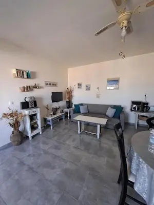 a living room with a couch and a table at House of Happiness Rhodos in Kritinía