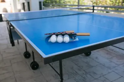 a blue ping pong table with three balls on it at Villa Euphoria in Gennadi
