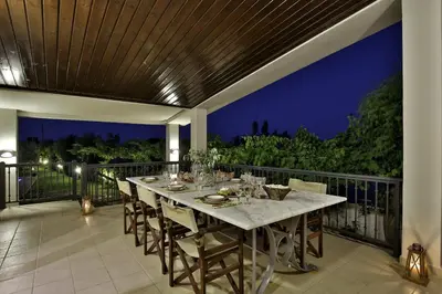 a dining table on the balcony of a house at Villa Euphoria in Gennadi
