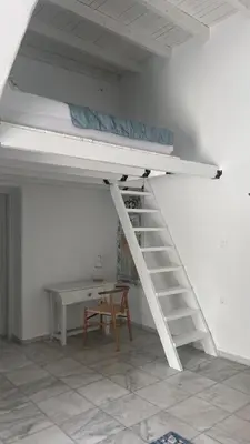 a white bunk bed in a room with a desk at ''TSI TSI' traditional home & private Pool' in Kalithies