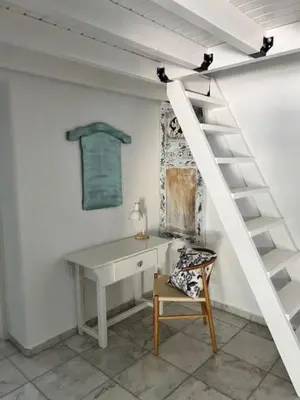 a room with a desk and a ladder and a chair at ''TSI TSI' traditional home & private Pool' in Kalithies