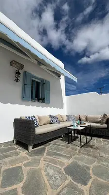 a patio with two couches and a table in front of a building at ''TSI TSI' traditional home & private Pool' in Kalithies