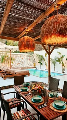a table and chairs under an umbrella on a patio at City Compass Sunset Villa in Rhodes Town