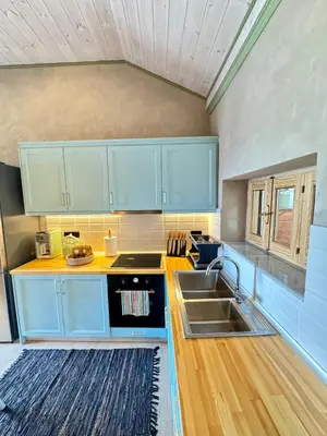 a kitchen with blue cabinets and a sink at City Compass Sunset Villa in Rhodes Town