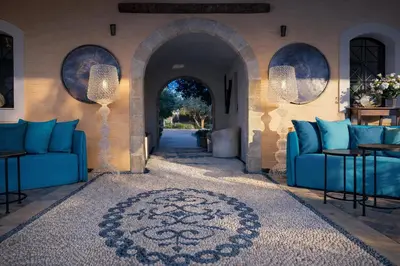 a living room with blue couches and an archway at Palazzo Navarone in Líndos