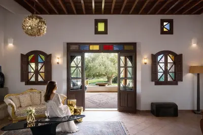 a woman sitting on a couch in a living room at Palazzo Navarone in Líndos
