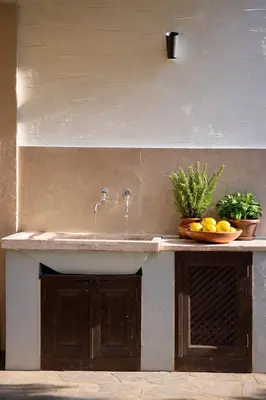 a bathroom sink with a bowl of fruit on a counter at Palazzo Navarone in Líndos