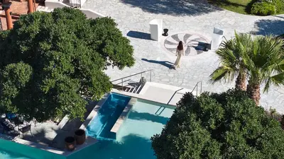 an overhead view of a swimming pool with trees at Palazzo Navarone in Líndos