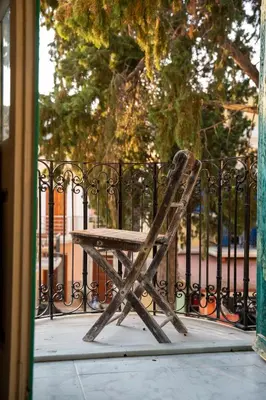 a wooden bench sitting in front of a fence at Vavana Studios in Symi