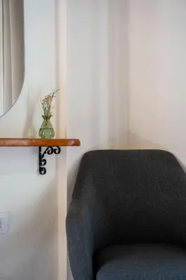 a chair in a room with a mirror at Vavana Studios in Symi