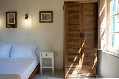 a bedroom with a bed and a wooden door at Vavana Studios in Symi