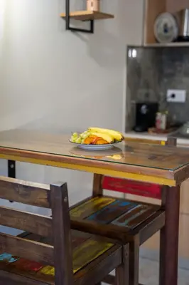 a table with a plate of fruit on top of it at Vavana Studios in Symi