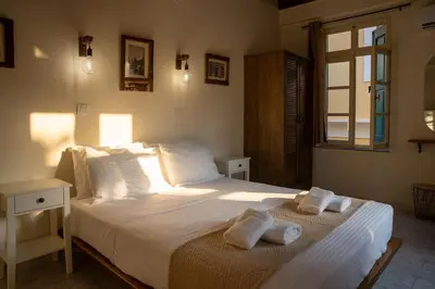 a bedroom with a large bed with towels on it at Vavana Studios in Symi