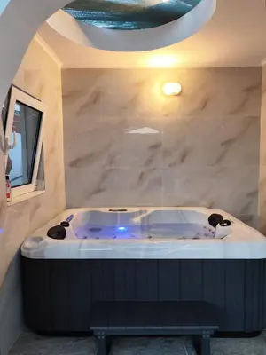 a bath tub in a room with a stone wall at Mannas House 2 in Émbonas