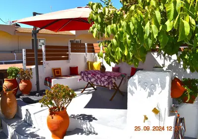 a patio with a table and chairs and an umbrella at Mannas House 2 in Émbonas