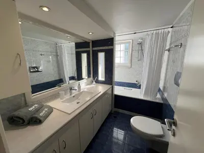 a bathroom with a sink and a toilet and a tub at Aura Apartment in Rhodes Town