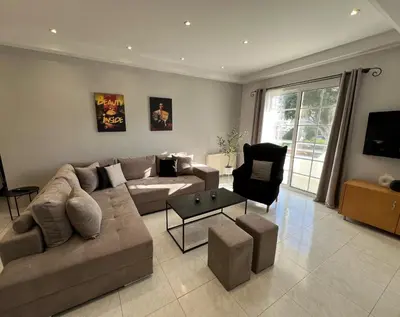 a large living room with a couch and a chair at Aura Apartment in Rhodes Town
