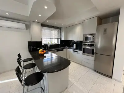 a kitchen with a black counter top and stainless steel appliances at Aura Apartment in Rhodes Town