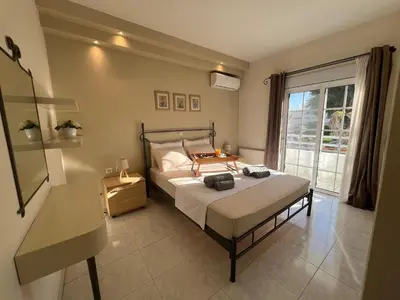 a bedroom with a bed and a large window at Aura Apartment in Rhodes Town