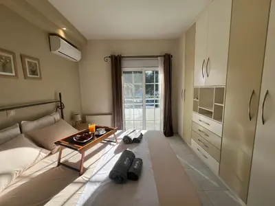 a bedroom with a bed and a table in it at Aura Apartment in Rhodes Town