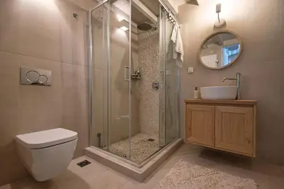 a bathroom with a shower and a toilet and a sink at Melenia House in Koskinou