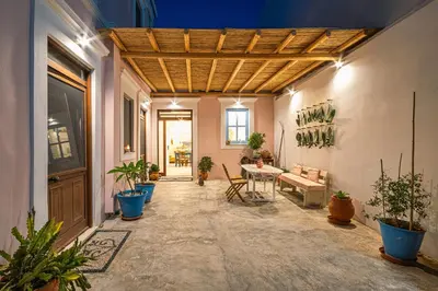 a hallway with a table and potted plants at Melenia House in Koskinou