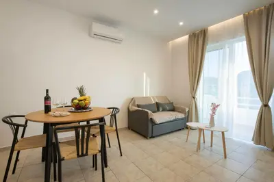 a living room with a table and a couch at Kathy's apartments in Archaggelos in Archangelos
