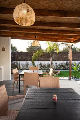 an outdoor dining area with a table and chairs at Kathy's apartments in Archaggelos in Archangelos