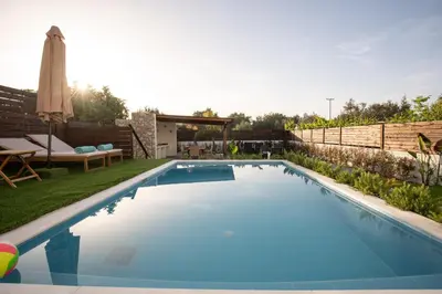 a swimming pool in the backyard of a house at Kathy's apartments in Archaggelos in Archangelos