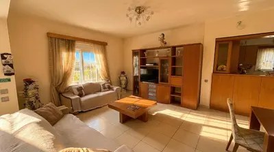 a living room with a couch and a table at Tharreni's house in Lindos in vlicha
