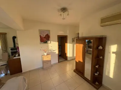a living room with a room with a table and a room at Tharreni's house in Lindos in vlicha