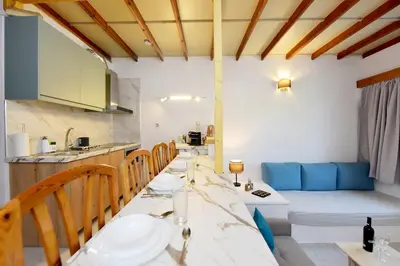 a kitchen and dining room with a table and chairs at Liri - Family paradise in Ialyssos
