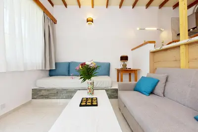 a living room with a couch and a table at Liri - Family paradise in Ialyssos