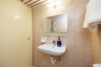 a bathroom with a sink and a mirror at Liri - Family paradise in Ialyssos