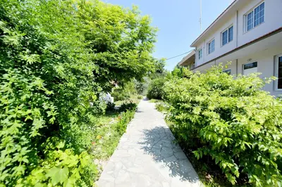 a garden path next to a building at Liri - Family paradise in Ialyssos