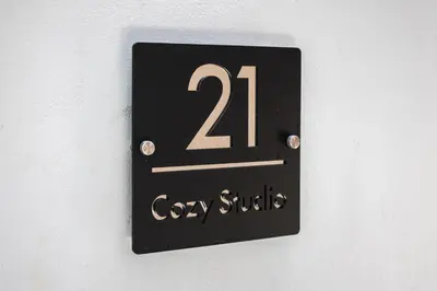 a black clock on a white wall with at Cozy studio in Rhodes Town