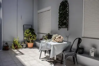 a table and chairs in a room with plants at Cozy studio in Rhodes Town
