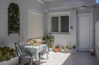 a room with a table and chairs and plants at Cozy studio in Rhodes Town
