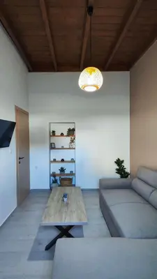 a living room with a couch and a table at Luna Grande in Archangelos