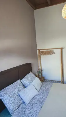 a bedroom with a bed with two pillows on it at Luna Grande in Archangelos