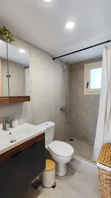 a bathroom with a toilet and a sink at Luna Grande in Archangelos