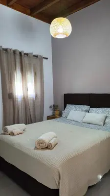 a bedroom with a bed with towels on it at Luna Grande in Archangelos