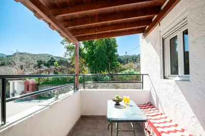 a balcony with a table and a view at Giannis Place in Arnítha