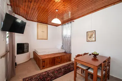 a room with a desk and a bed and a table at Giannis Place in Arnítha
