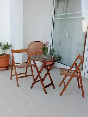two chairs and a table and a table and a chair at Pefkos Crystal Bay SELF-CATERED Studios and Apartments in Pefki Rhodes