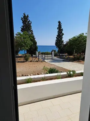 a view of the ocean from a door at Pefkos Crystal Bay SELF-CATERED Studios and Apartments in Pefki Rhodes